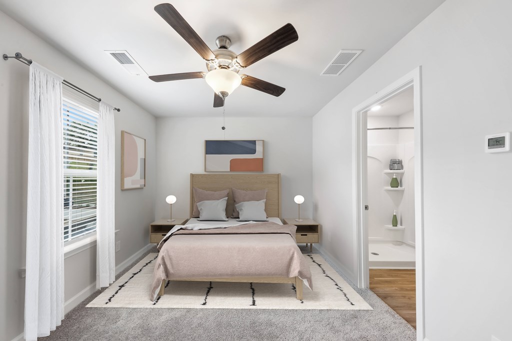 a bedroom with a bed and a ceiling fan