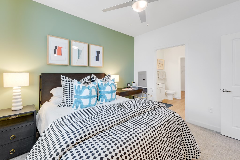 a bedroom with a large bed and a ceiling fan