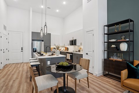 A modern kitchen with a dining table and chairs.