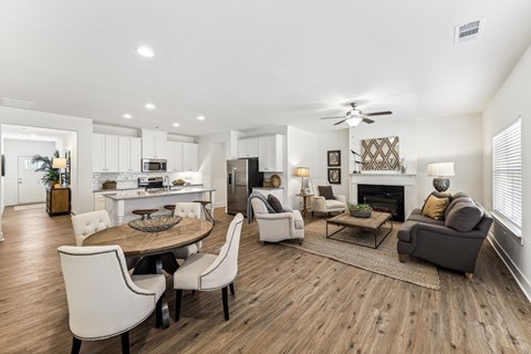 A modern living room with a dining table and chairs.