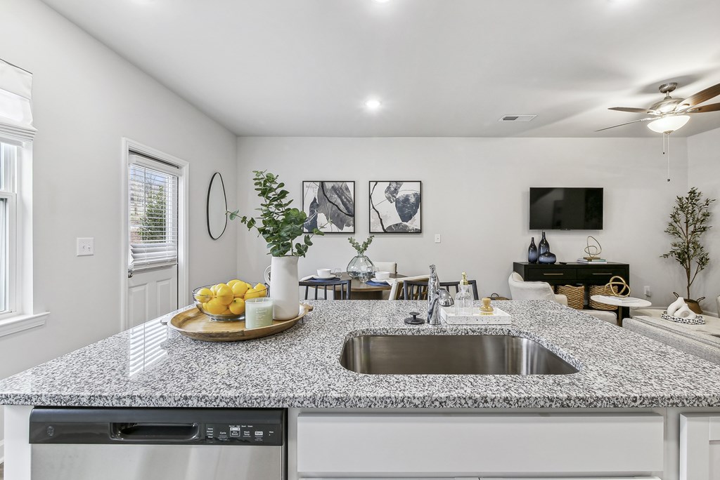 a kitchen with granite counter tops and a sink