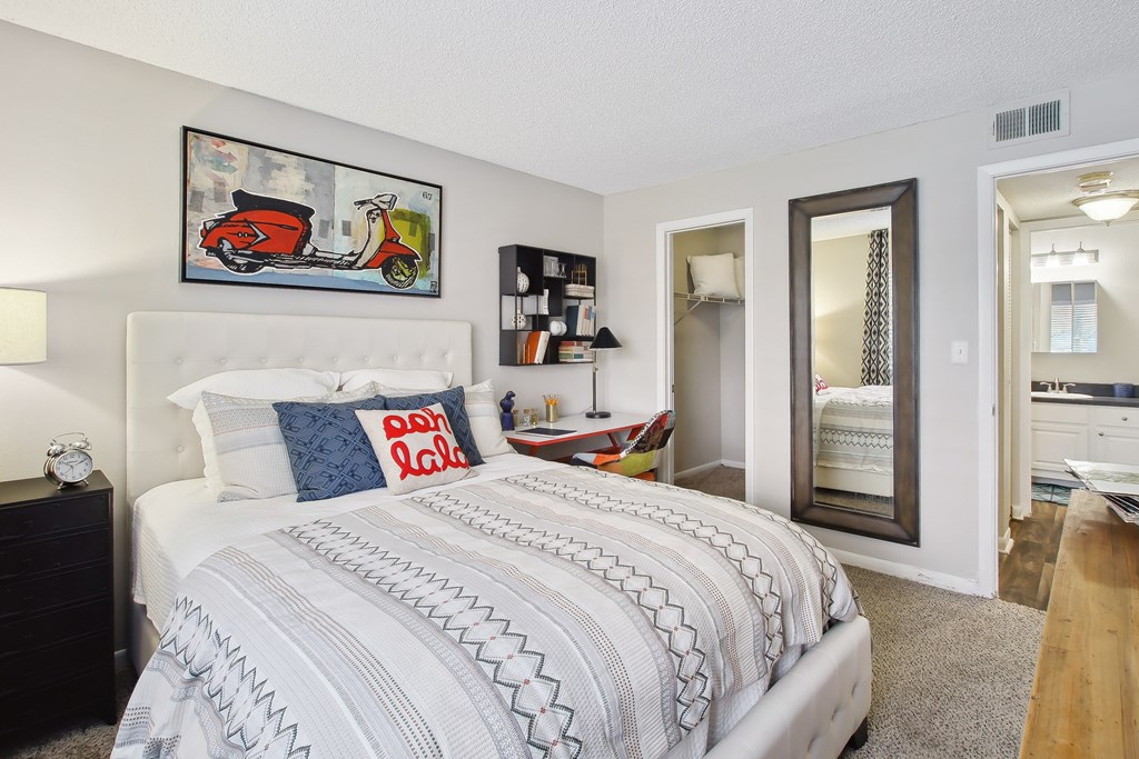 a bedroom with a bed and a mirror