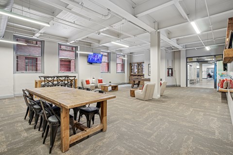 A conference room with a long wooden table and chairs.