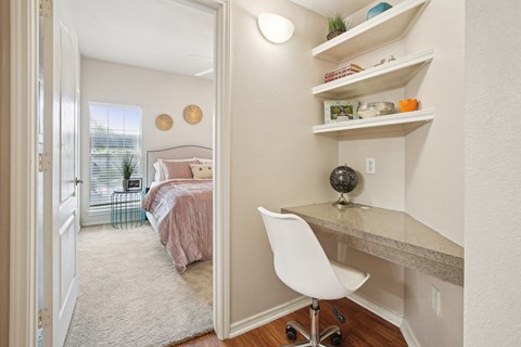 a bedroom with a bed and a desk with a chair
