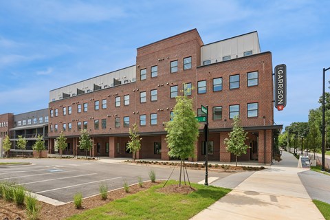 A modern building with a sign that reads "GARRISON" in front of it.