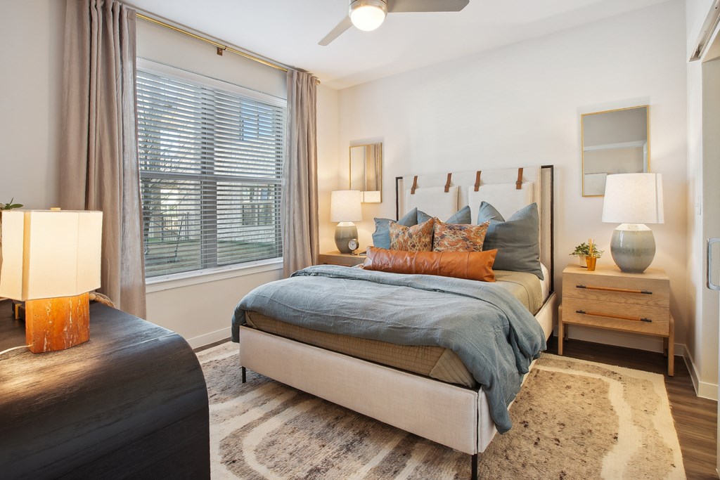 a bedroom with a bed and a large window