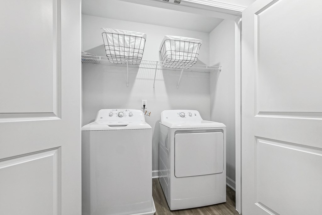 a washer and dryer in a white laundry room with white walls