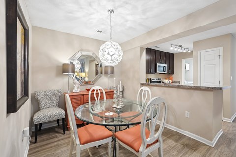 A dining room with a glass table and chairs.