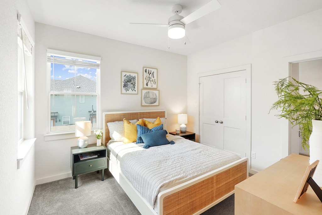 a bedroom with a large bed and a large window