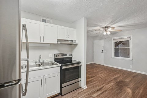 A kitchen with white cabinets and stainless steel appliances.