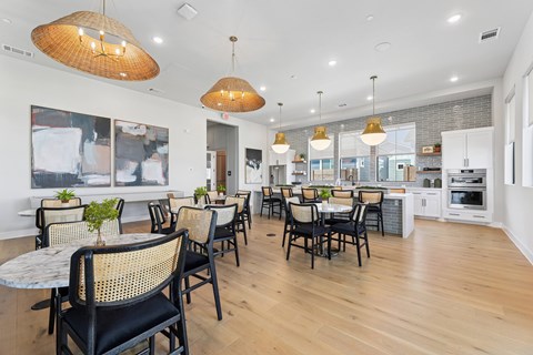 A modern dining room with a white table and chairs.