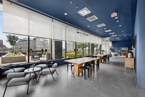 A modern dining area with a long table and chairs.