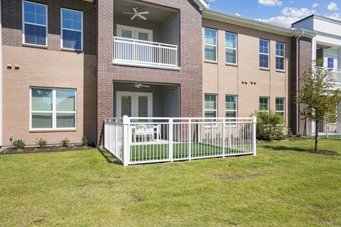A building with a white fence in front of it.