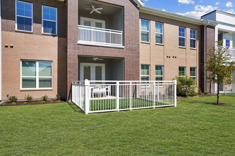 A building with a white fence in front of it.