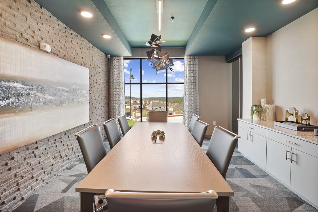 a conference room with a long table and a large window