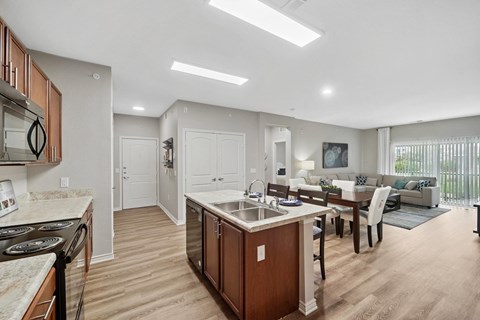 A modern kitchen with wooden cabinets and a central island.