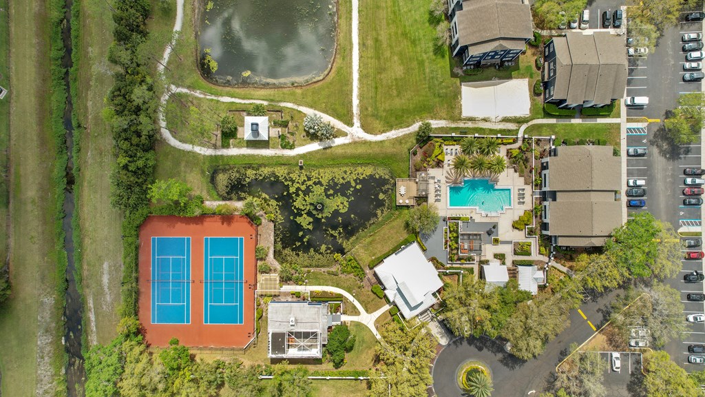 a birdseye view of a house and its backyard with a pool and yard