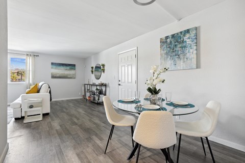 a dining room with a table and chairs and a living room