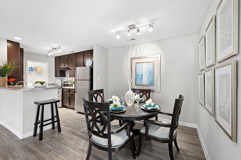 A dining room with a table set for four.
