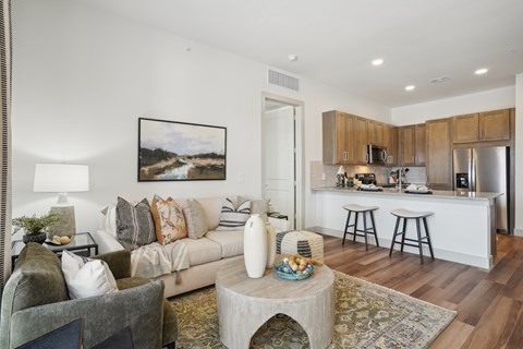A living room with a grey couch and a coffee table in front of it.
