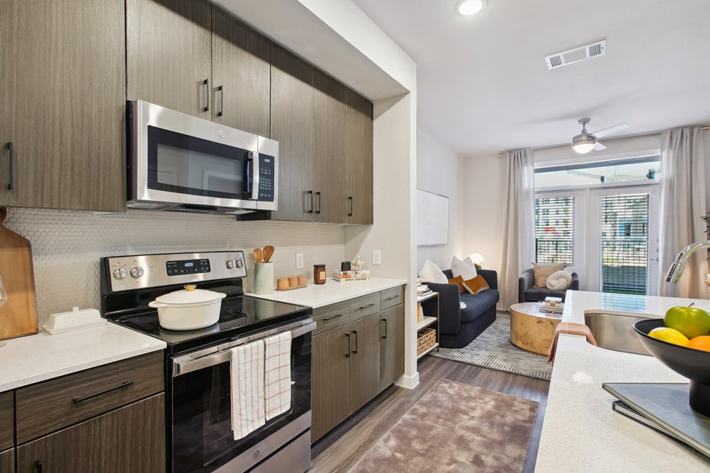 an open kitchen and living room with a view of a living room