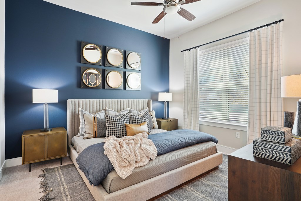 a bedroom with a bed and a ceiling fan