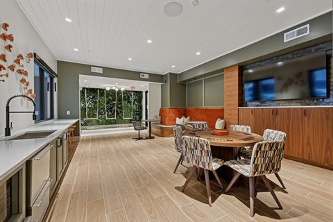 A modern kitchen with a dining table and chairs.