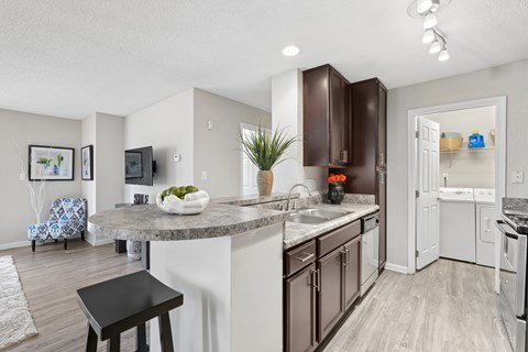 A kitchen with a white counter top and brown cabinets.