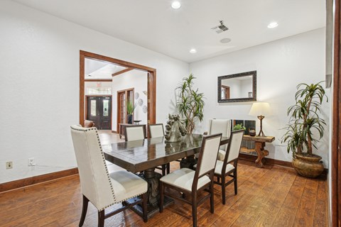 a dining room with a wooden table and chairs