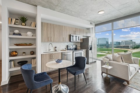 A modern kitchen with a dining table and chairs.