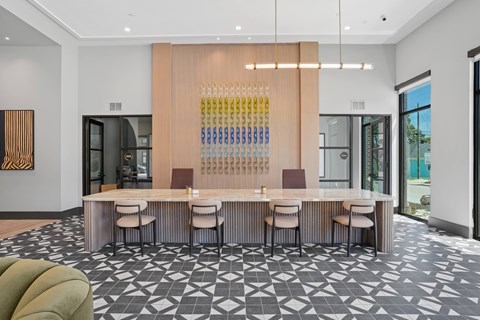 A modern dining room with a long table and chairs.