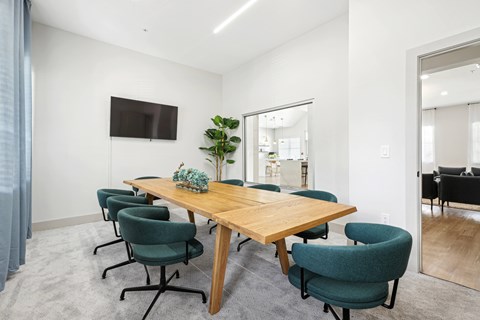 a conference room with a wooden table and blue chairs