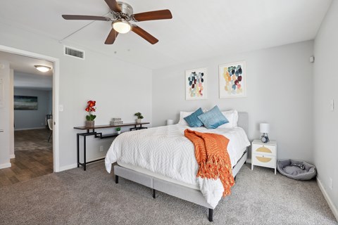 a bedroom with a bed and a ceiling fan
