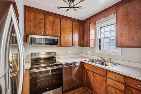 A kitchen with wooden cabinets and stainless steel appliances.