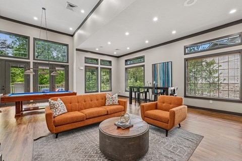 A living room with a pool table and a sofa.