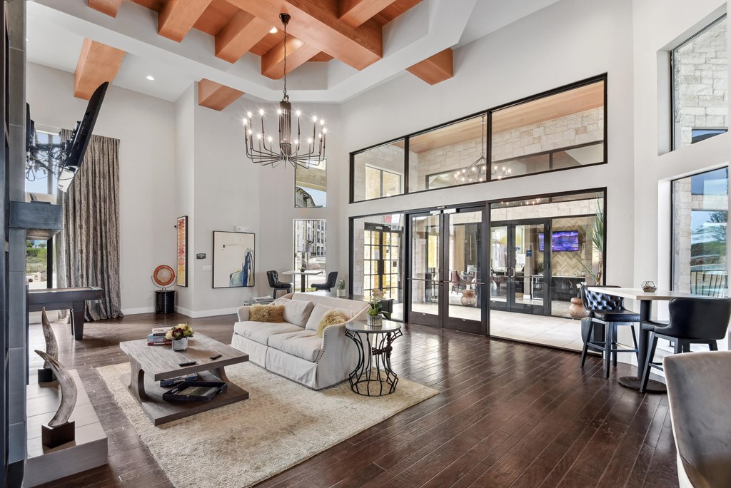 a living room with a couch and a coffee table in front of large windows