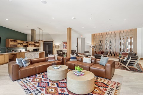 A living room with a brown leather couch and a wooden coffee table.