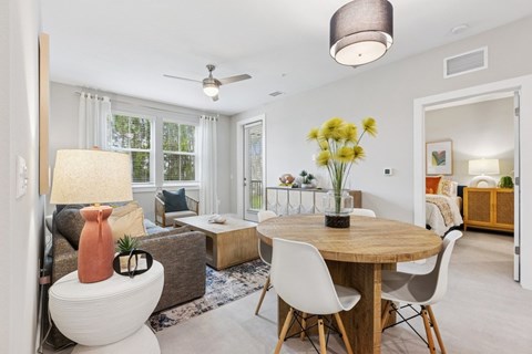 A well-lit, modern dining room with a round table and chairs.