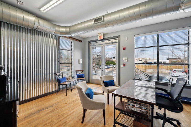 a conference room with a table and chairs in front of a window