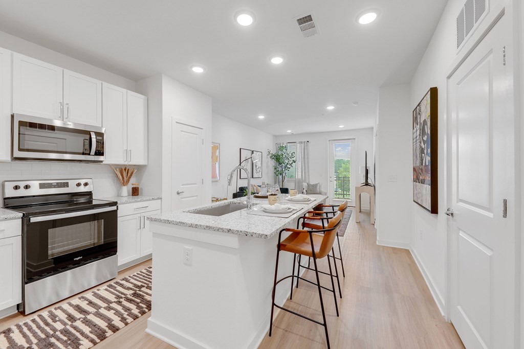 a large kitchen with white cabinets and a white counter top