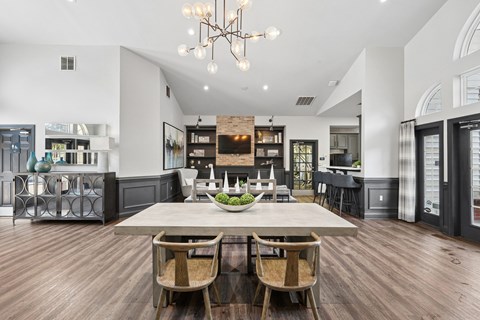 A dining room with a wooden table and chairs.