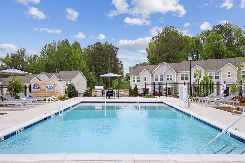our apartments have a resort style pool with chairs and tables