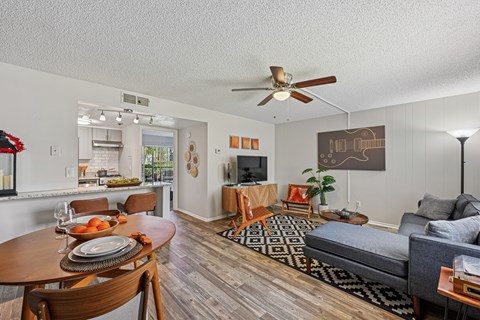 A living room with a grey couch and a wooden table.
