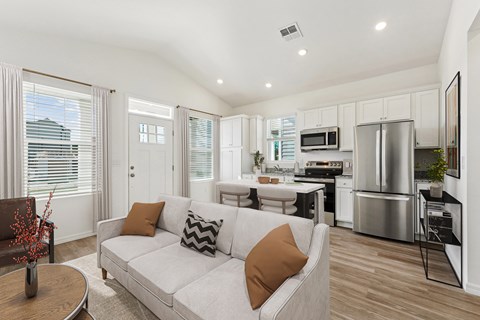 A modern living room with a white couch and a wooden coffee table.