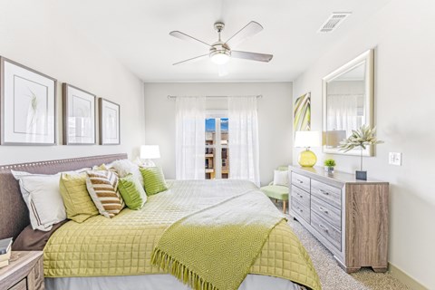 a bedroom with a bed and a ceiling fan