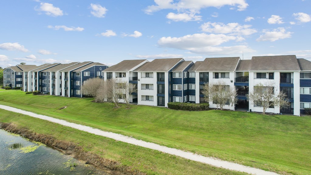 an image of an apartment building next to a body of water