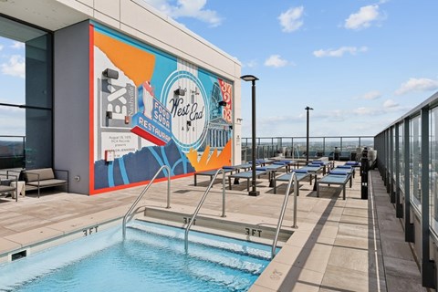 A pool with a mural on the wall next to it.