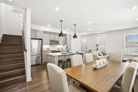 A modern kitchen with a dining table and chairs.
