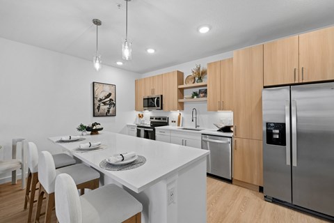 A modern kitchen with a dining table and chairs.