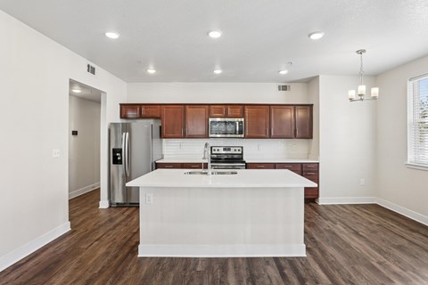 A kitchen with brown cabinets and a white island.